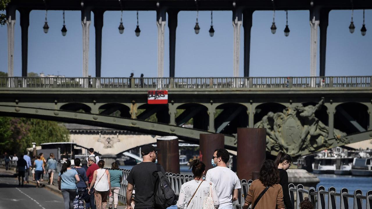 People enjoy the sun near the Bir-Hakeim bridge in Paris on April 26, 2020 on the 41st day of a lockdown in France. Picture: Alain Jocard/AFP