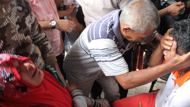 Relatives greet survivors at the Lake Toba ferry port on Tuesday. Picture: AFP