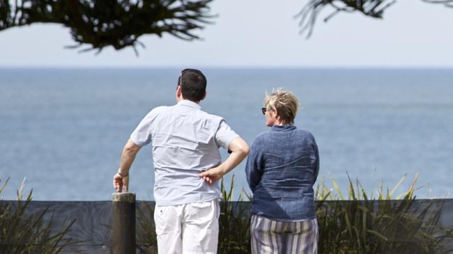People look out over one of many unsafe beach entry points at Stockton beach.