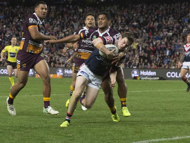 Luke Keary busts through the Broncos to score.