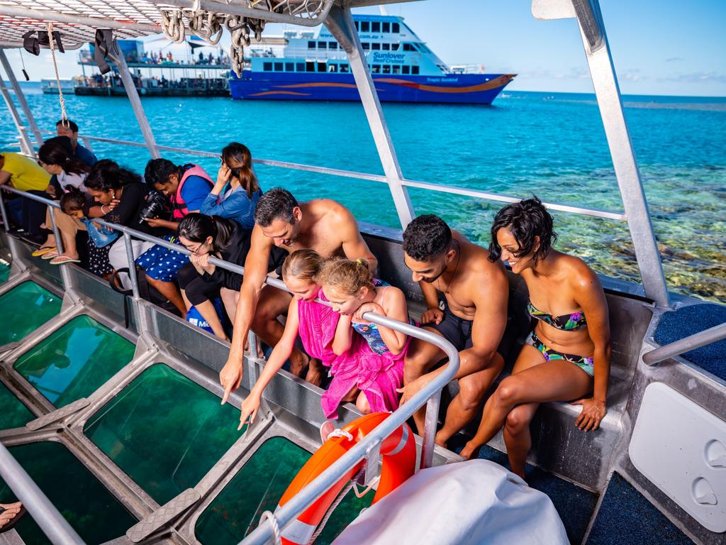 Visitors take a closer look at the reef on a glass-bottom boat tour.