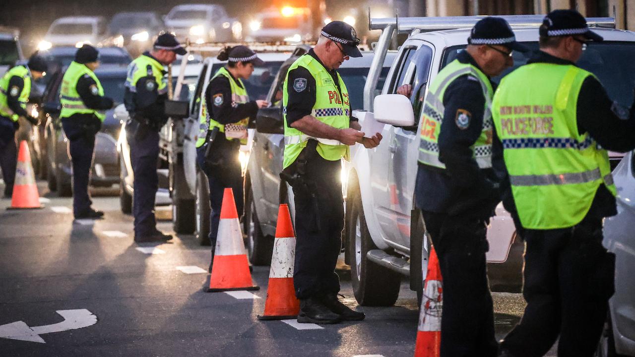 Police question drivers at a checkpoint in Albury on the NSW-Victoria border. Picture: David Gray/Getty Images