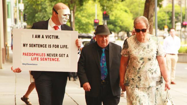 Vivian Frederick Deboo, centre, and his wife Margaret, right, are confronted by one of his victims "B", on November 1.