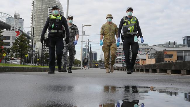 Police and Australian Defence Force personnel patrol Docklands in Melbourne during stage-four lockdown. Picture: David Crosling