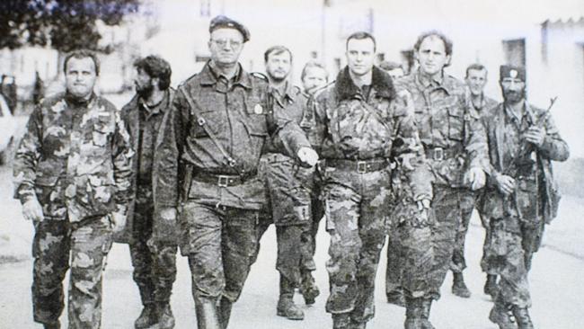 Zoran Tadic, far left, walks next to ultranationalist politician Vojislav Seselj.