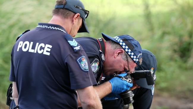 Police recover a hand gun from the Nerang River. Pic: Adam Head.