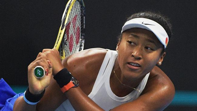 Naomi Osaka hits a return during the women's singles final against Ashleigh Barty.