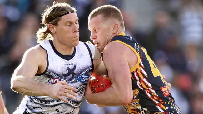 Mark Blicavs crunches Crows ruckman Reilly O’Brien.