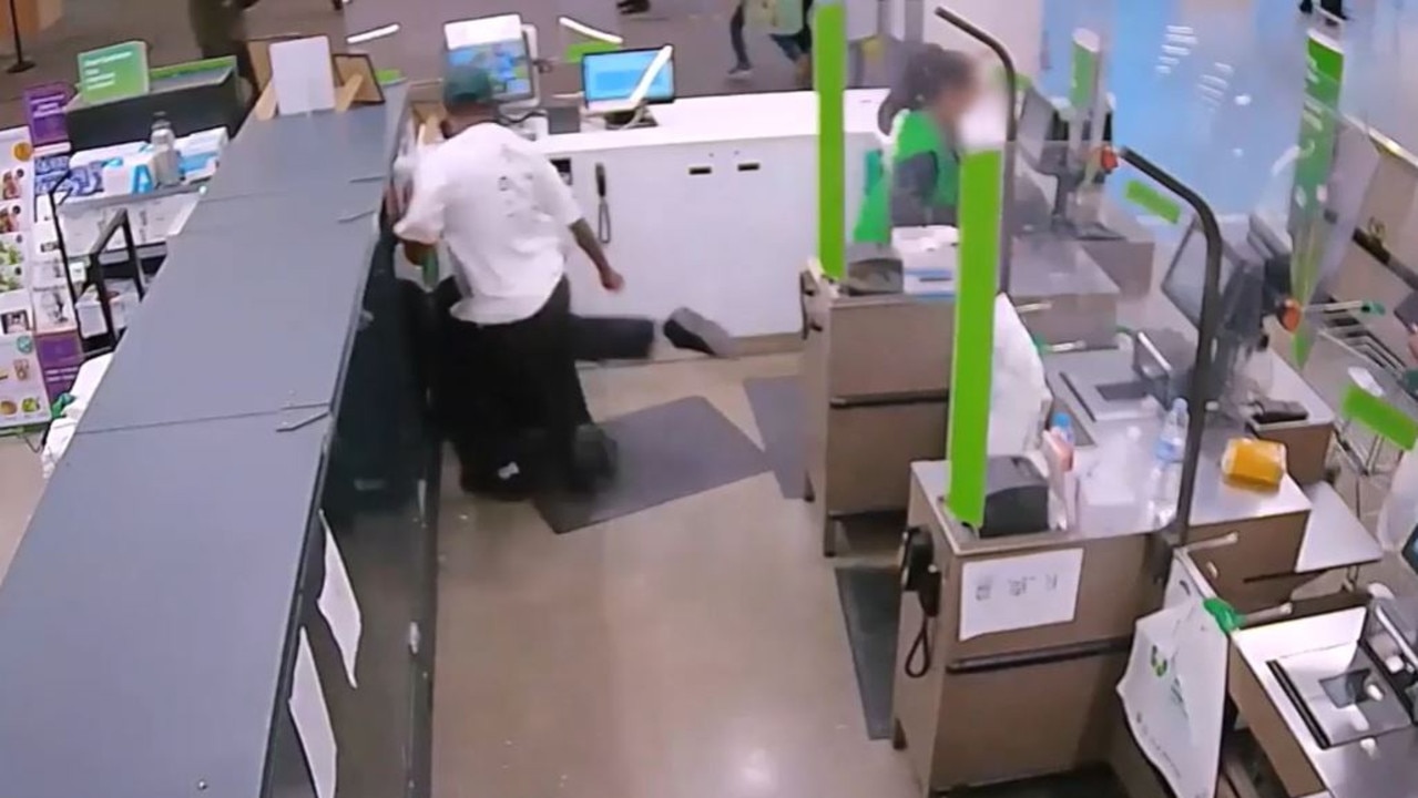 A male customer wearing a white shirt can be seen kicking a Woolies team member inside the service desk in Parramatta.