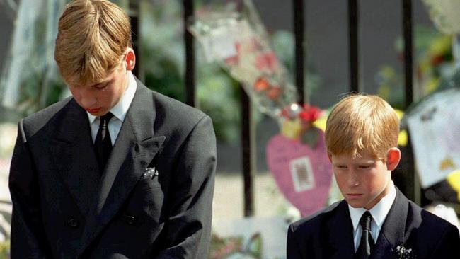 Prince William, left, then 15, and Prince Harry (12), bow their heads as Princess Diana’s coffin is taken out of Westminster Abbey. Picture: File