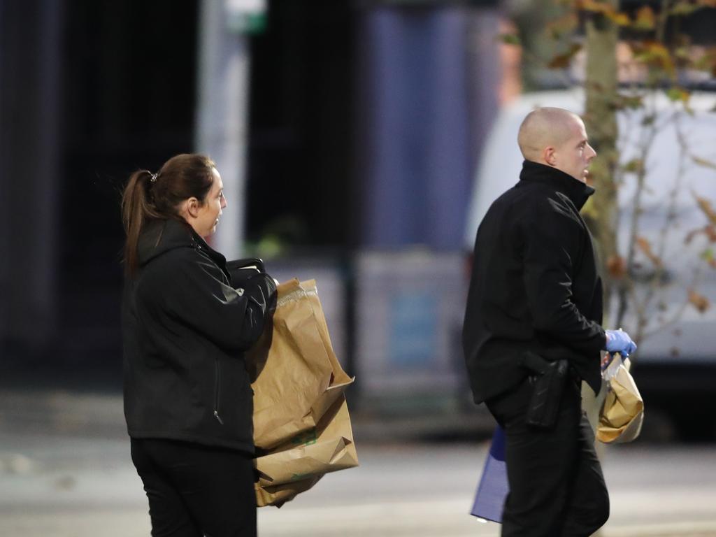 Police collect evidence from the scene in Argyle Place South in Carlton. Picture: David Crosling