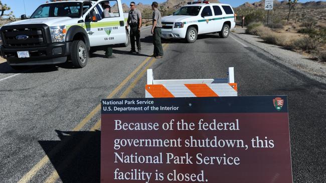 US Park Rangers stand at the closed gate to Joshua Tree National Park in California during the US government shutdown. Picture: AFP