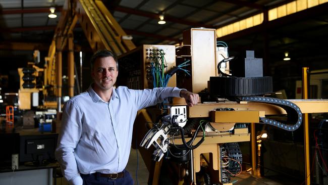 FBR’s chief technology officer Mark Pivac, in front of the prototype robotic bricklaying device.