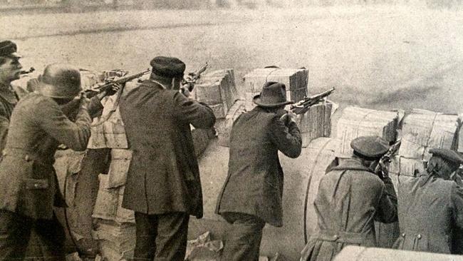 Soldiers and civilians behind a barricade during the January 1919 German Spartacist Uprising.