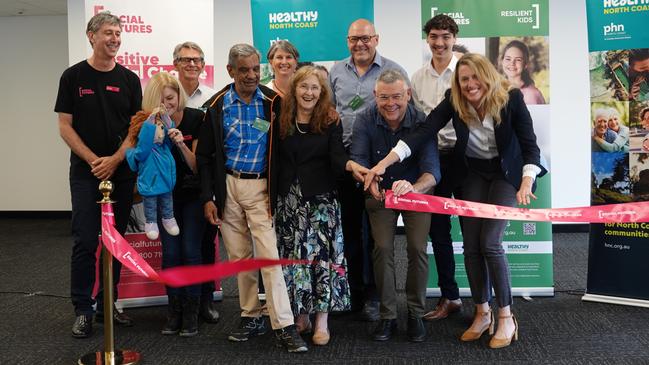 (Back row) Social Futures CEO Tony Davies, Family Centre CEO David Boutkan, Human Nature Therapy's Sharyn White, Lismore Mayor Steve Krieg, Trinity College 2022 Captain Daniel Pereira, (front row) Jack the Puppet, play therapist Lisa Wilson, Uncle Reg, Lismore MP Janelle Saffin, Emergency Management Minister Murray Watt and Healthy North Coast CEO Monica Wheeler.