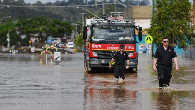 Emergency services, locals and property owners in flood waters in the central business district of Lismore during this year’s flood. Picture: Lyndon Mechielsen/The Australian