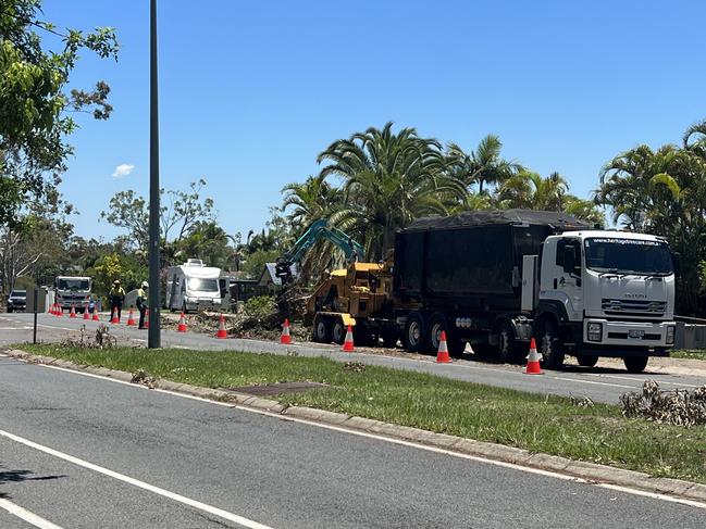 Clean-up crews at work on Discovery Drive in Helensvale. Picture: Keith Woods.