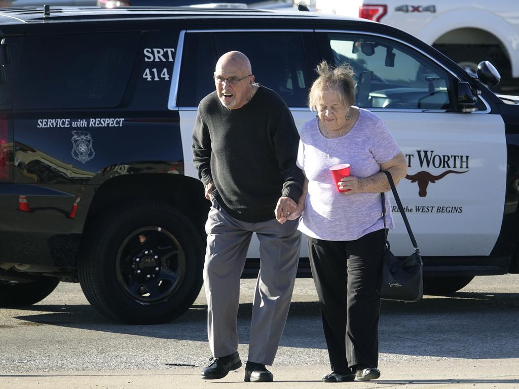 An elderly couple walks from West Freeway Church of Christ hours after a fatal shooting at the church. Picture: AP Photo/David Kent