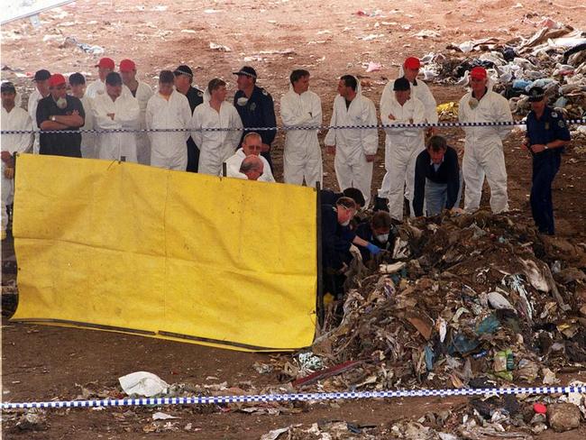 Police searchers form a guard a honour as the body of murder victim Megumi Suzuki is removed after being found buried at the Wingfield Dump in 2001. They searched the dump for more than a month under a scorching sun, moving about 1500 tonnes of rubbish.