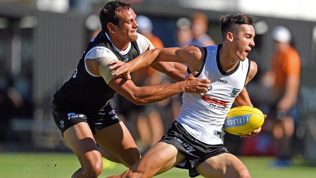 GOT HIM: Steven Motlop tackles Port Adelaide’s top draftee Connor Rozee in last week’s internal trial. Picture: TOM HUNTLEY.