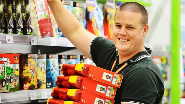 Kmart Fairfield store manager Kirk Benson stocks the shelves.