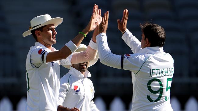 Iftikhar Ahmed (R) celebrates with fellow bowler Shaheen Shah Afridi. Picture: AAP/Richard Wainwright