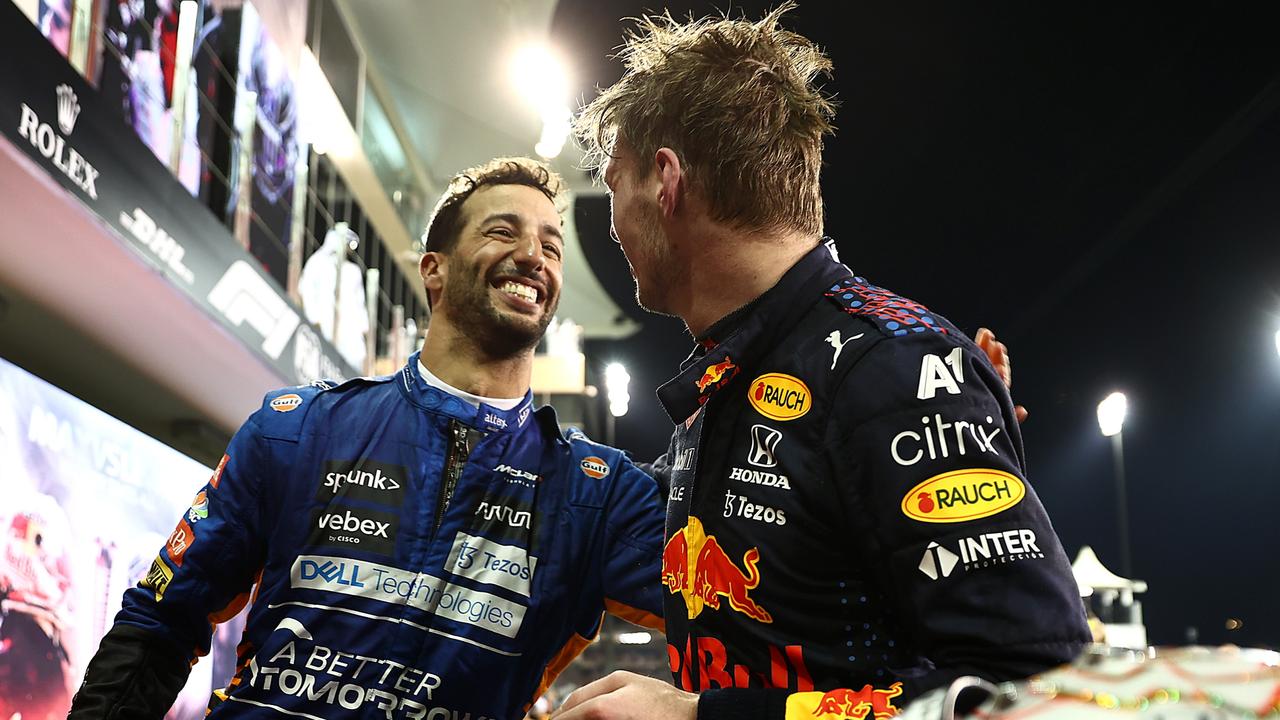 ABU DHABI, UNITED ARAB EMIRATES - DECEMBER 12: Race winner and 2021 F1 World Drivers Champion Max Verstappen of Netherlands and Red Bull Racing celebrates with his Daniel Ricciardo of Australia and McLaren F1 in parc ferme during the F1 Grand Prix of Abu Dhabi at Yas Marina Circuit on December 12, 2021 in Abu Dhabi, United Arab Emirates. (Photo by Mark Thompson/Getty Images)