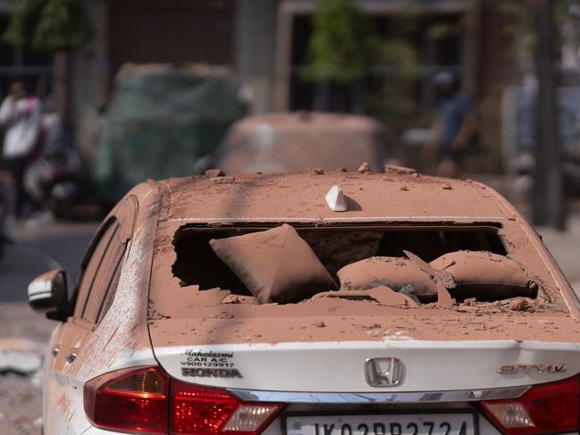 Damage on vehicles seen next to the spot of an aerial attack from the Pakistan side that damaged a residential building in Jammu, India. Picture: Getty