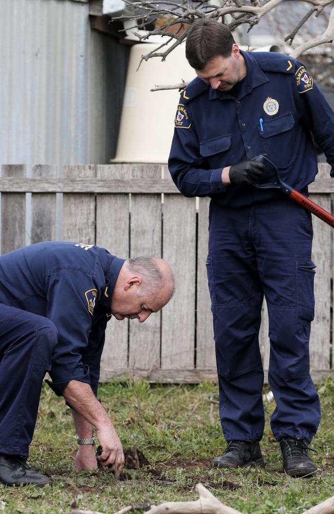 Tasmania Police search for bullet casings in the field in East Street, Campbell Town, adjacent to the residence where Shane Barker was murdered in 2009. Picture: LUKE BOWDEN