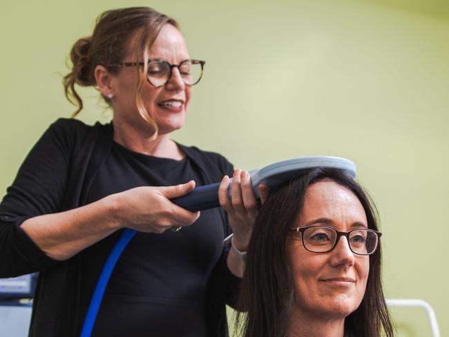 Mater Clinical Research Coordinator Tamara Powell uses the electromagnetic coil on Jette Beek, a TAURUS.2 trial participant. Source: Supplied.