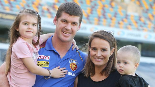 Brisbane Lions player Jonathan Brown (in blue shirt) with daughter Olivia, wife Kylie and son Jack announcing his retirement from the AFL in 2014.