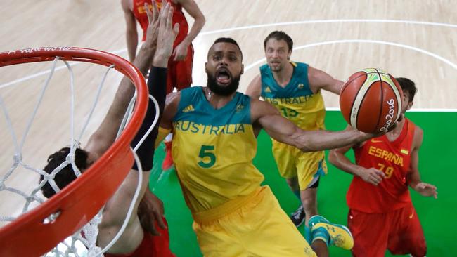 Patty Mills of Australia drives to the basket against Spain.