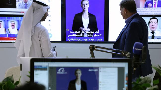 Journalists watch a video by AI anchor “Fedha” on the Twitter account of the Kuwait news service. Picture: AFP