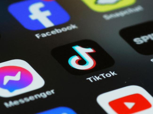 (FILES)  In this photo illustration, the TikTok app is seen on a phone on March 13, 2024 in New York City. TikTok sharply denounced the passage on April 20, 2024,  by the US House of Representatives of a bill that threatens to ban the popular social-media platform unless it severs its ties to Beijing. (Photo by Michael M. Santiago / GETTY IMAGES NORTH AMERICA / AFP)