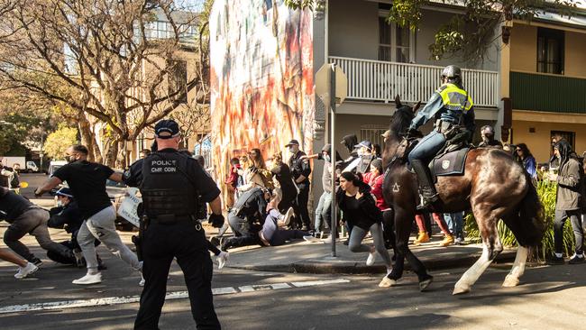 Protesters dash from mounted police in Chippendale, Sydney. Picture: Julian Andrews.