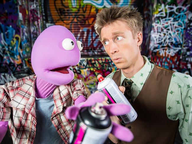 Caught in the act: Australian comedian Sammy J and puppet Randy indulge in some questionable street art in Melbourne's CBD.