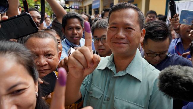 Hun Manet, commander of the Royal Cambodian Army and eldest son of then Prime Minister Hun Sen, shows his finger after he cast his vote at a polling station in July. Hun Manet has since become the country's new leader after his father Hun Sen called time on nearly four decades of hardline rule. Picture: STR/AFP