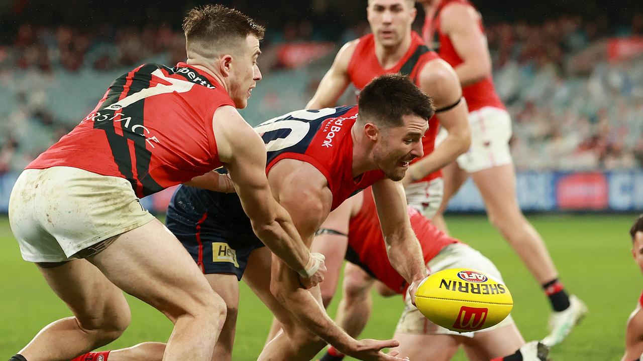 Alex Neal-Bullen (centre) had success nullifying Essendon captain Zach Merrett (left) in Melbourne’s 17-point win on Saturday night. Picture: Kelly Defina / Getty Images