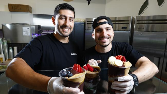 Oakberry Acai is a new health food eatery at the corner of Cairns Esplanade and Shields Street Mall, exclusively offering acai bowls and smoothies. Eduardo Cavalcante and store manager Matheus Ramos prepare a variety of acai bowls, which have proved popular with health concious locals and tourists. Picture: Brendan Radke