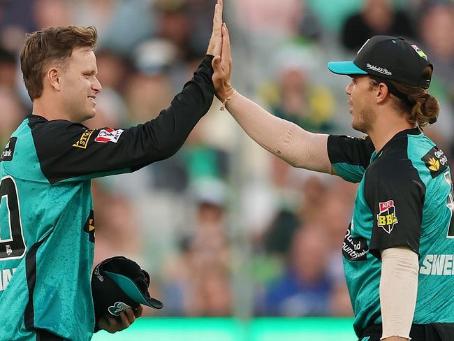 MELBOURNE, AUSTRALIA - DECEMBER 18: Matt Kuhnemann and Mitch Swepson of the Heat celebrate the wicket of Sam Harper of the Stars during the BBL match between Melbourne Stars and Brisbane Heat at Melbourne Cricket Ground, on December 18, 2024, in Melbourne, Australia. (Photo by Morgan Hancock/Getty Images)