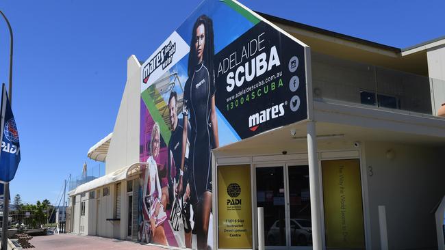 The mural featuring women and men in wetsuits on the side of the building. Picture: Tricia Watkinson