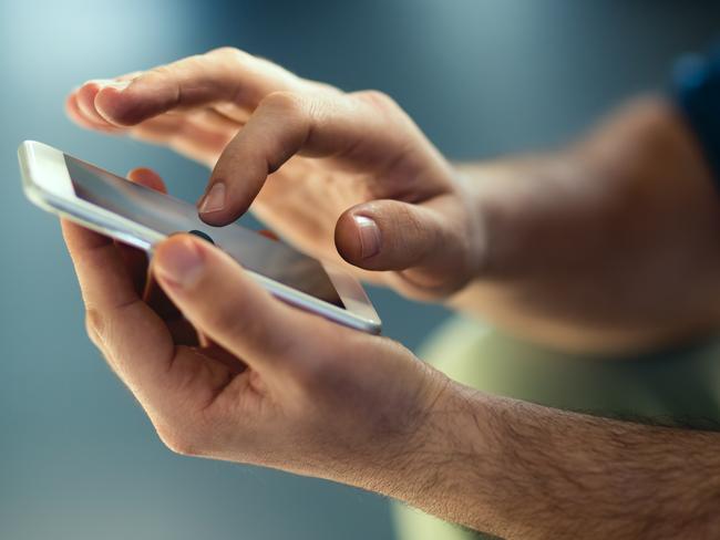 Generic Male hands typing on smartphone. Picture: Istock