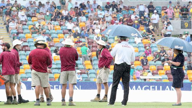 Ground staff look on as rain delays play on day one of the first Test. Picture: AAP.