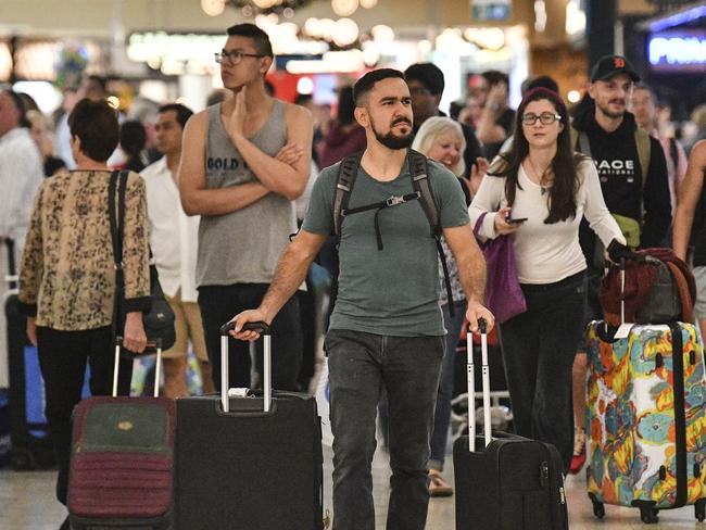 Travellers are seen at Overseas Arrivals and Departures (OAD) at Sydney's International Airport in Sydney, Monday, December 17, 2018. (AAP Image/Brendan Esposito) NO ARCHIVING