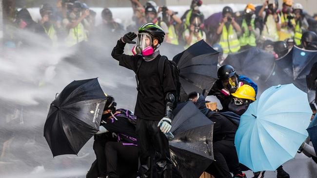 Last year, Hong Kong pro-democracy protesters had police fire water cannons at them in the streets. Picture: Isaac Lawrence/AFP