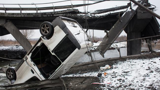 A destroyed van and bridge in Irpin, Ukraine.