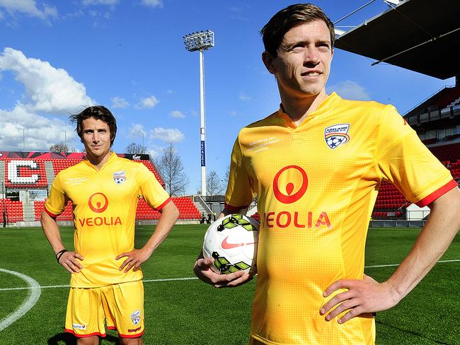 Craig Goodwin, right, and Michael Marrone in the new yellow strips for their upcoming game against Liverpool. Picture: Mark Brake