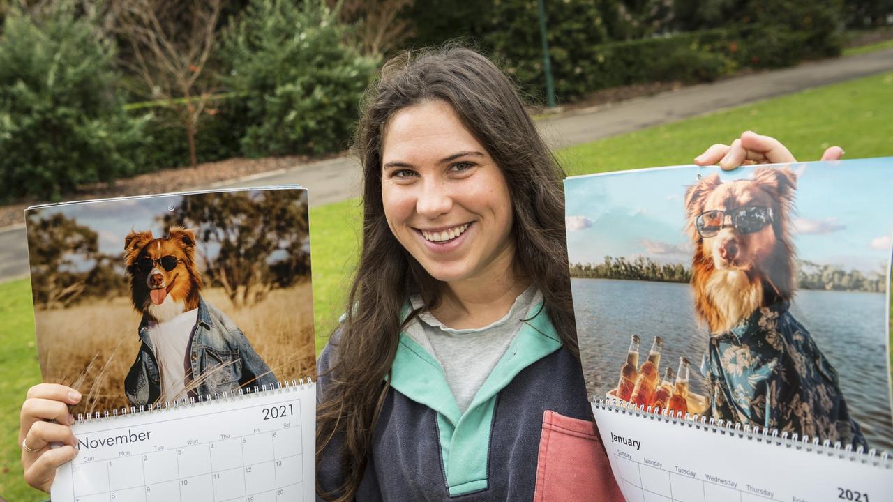 Darby Brown with the 2021 calendar featuring Australian Shepherd Austin. Pictures: Kevin Farmer.