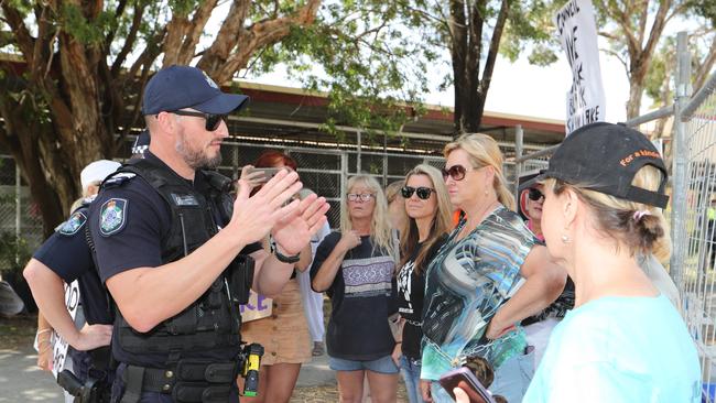 Black Swan Lake protest at Bundall goes to another level, with protesters chaining themselves to the fence and then getting themselves arrested after running onto the worksite and stopping the trucks. Police inform protesters of the situation. Picture Glenn Hampson