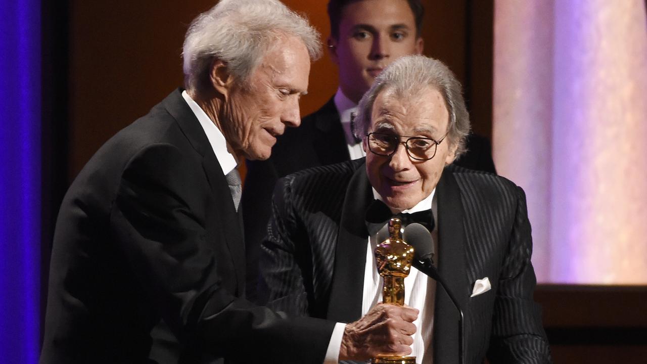 Clint Eastwood, left, presents composer Lalo Schifrin with an honorary Oscar.